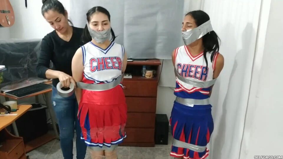 Tied Up Cheerleader Rivals United in a Tape Gagged Kiss — gallery-4