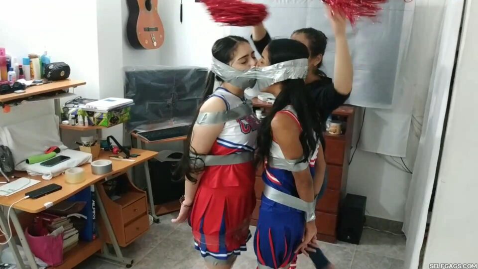 Tied Up Cheerleader Rivals United in a Tape Gagged Kiss — gallery-5