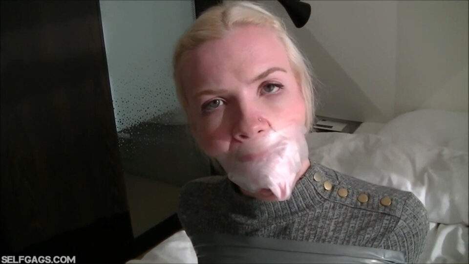 Scandinavian Blonde: All Gagged Up with Inflatable Butterfly, Vet Wrap and a Cruel Double Sock Stuffing Wrapped in Her Mouth with Clear Medical Tape — gallery-6